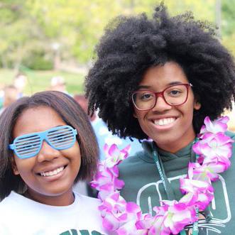 Two students smile at an event